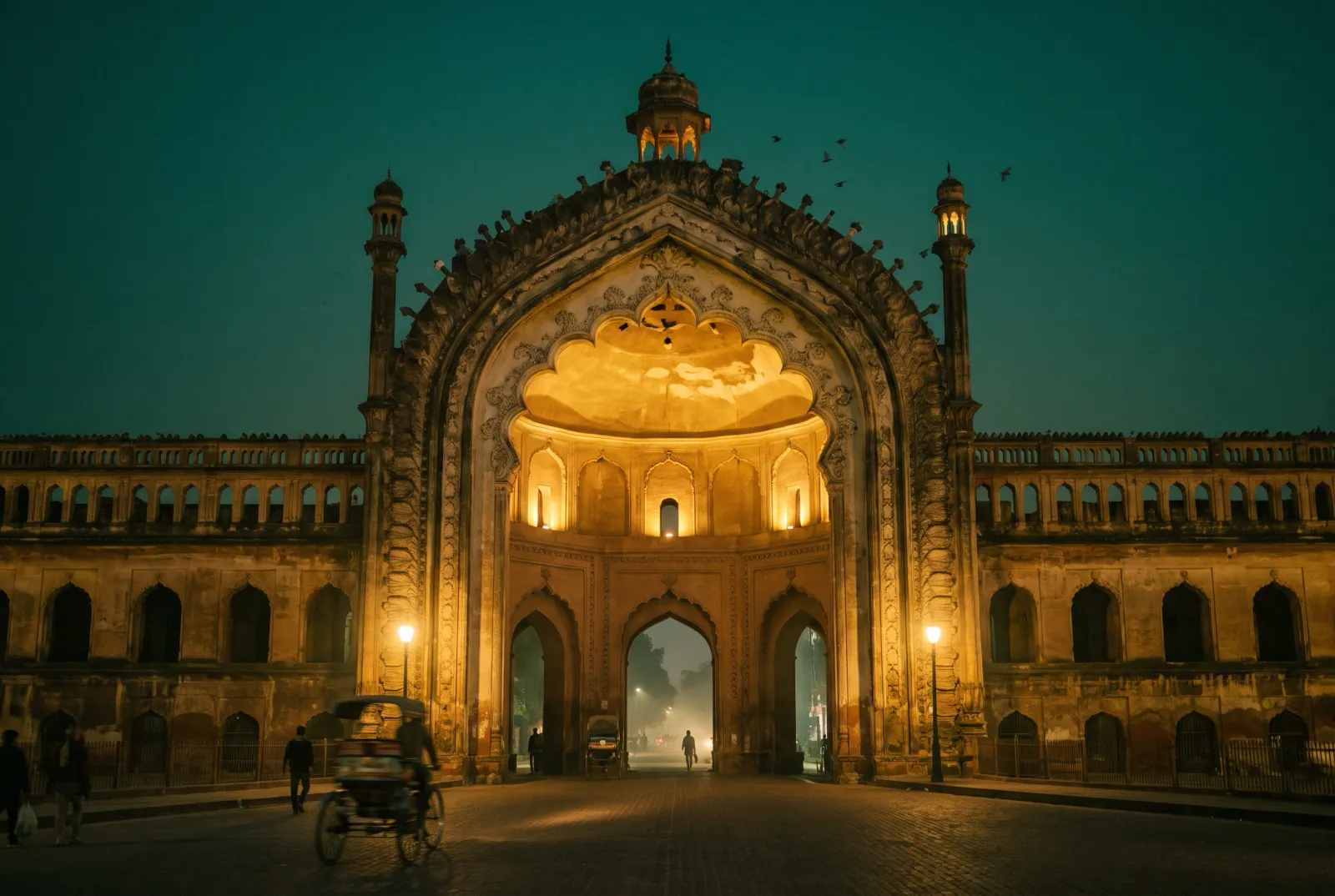 The Rumi Darwaza gateway in Lucknow glowing with lamplight at dusk